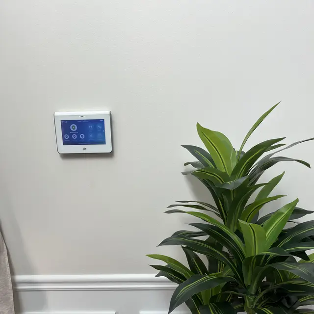 Security system touchscreen panel mounted on a wall