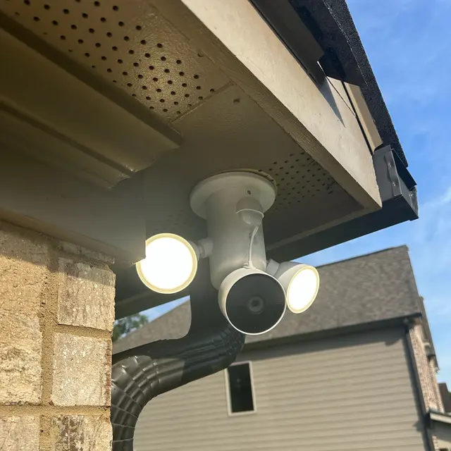 Floodlight camera installed under a roof eave