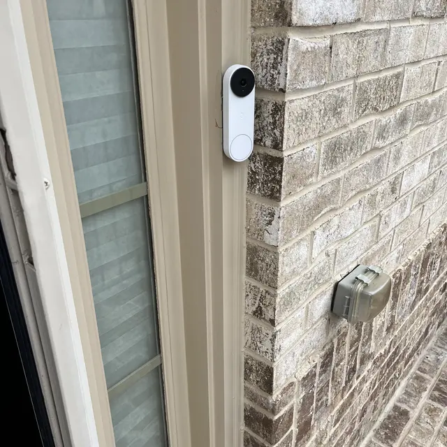 Video doorbell installed beside a front door